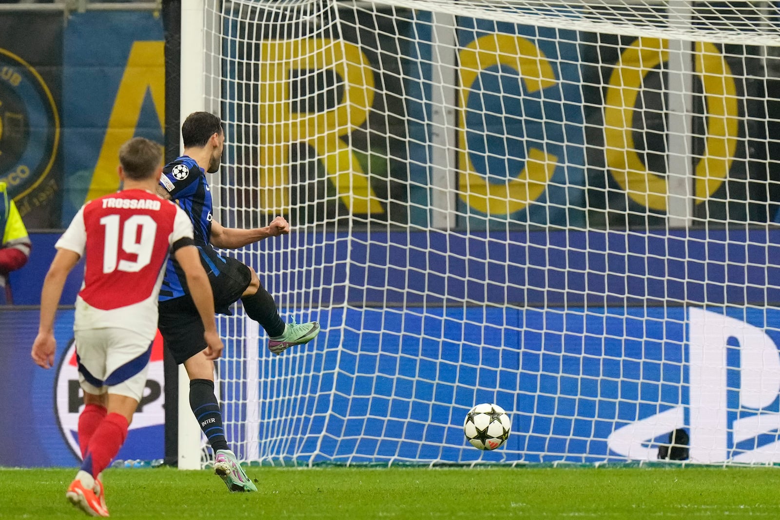 Inter Milan's Hakan Calhanoglu scores on a penalty his side's opening goal during a Champions League opening phase soccer match between Inter Milan and Arsenal at the San Siro stadium in Milan, Italy, Wednesday, Nov. 6, 2024. (AP Photo/Luca Bruno)