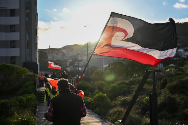 Indigenous Māori carry a sovereignty flag as they prepare to march to Parliament in Wellington, New Zealand, Tuesday, Nov. 19, 2024. (AP Photo/Mark Tantrum)