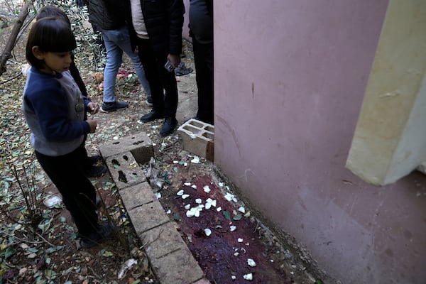 A child looks at blood at the site where Jaafar Dababsah, a Palestinian Hamas commander was killed in a raid by Israeli forces, in the village of Talouza, near the West Bank city of Nablus, Tuesday, Jan. 7, 2025. (AP Photo/Majdi Mohammed)