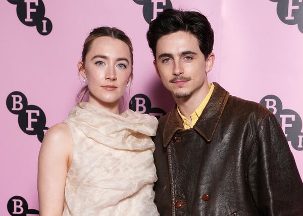 Saoirse Ronan, left, and Timothee Chalamet pose for photographers upon arrival at the photo call for an 'In Conversation' event at the BFI Southbank, on Wednesday, Dec. 18, 2024, in London. (Photo by Scott A Garfitt/Invision/AP)