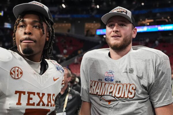 Texas players celebrate victory after a quarterfinals College Football Playoff game against Arizona State, Wednesday, Jan. 1, 2025, in Atlanta. Texas won 39-31 in two overtime periods. (AP Photo/Brynn Anderson)