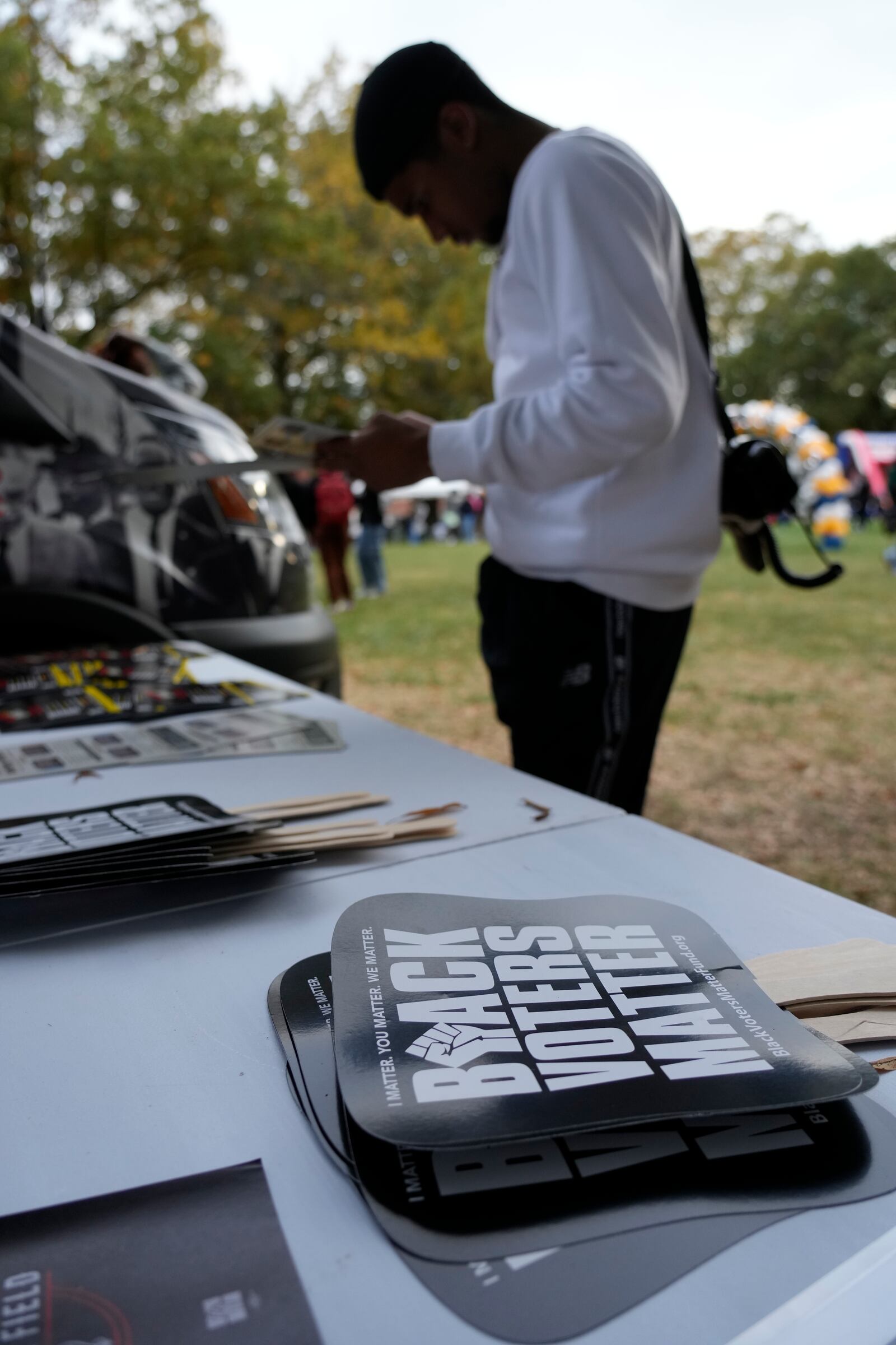 A student looks over material during a get out the vote rally at North Carolina A&T in Greensboro, N.C., Monday, Oct. 28, 2024. (AP Photo/Chuck Burton)