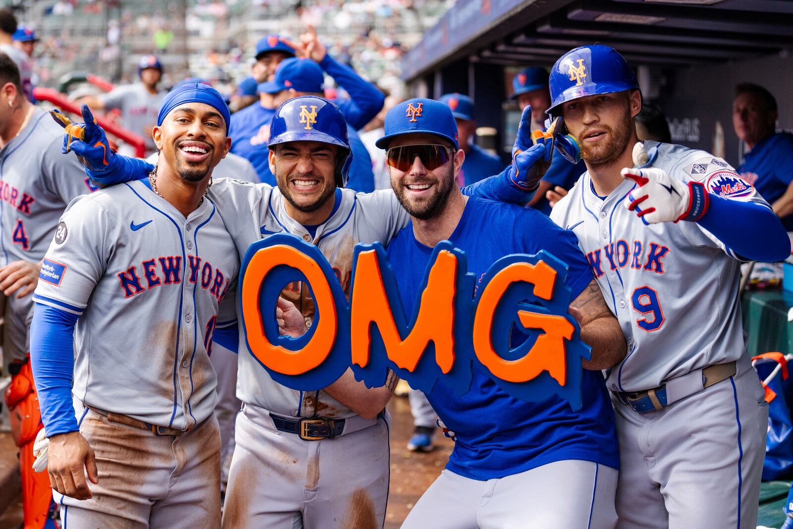 New York Mets' Francisco Lindor, left, Jose Iglesias, left center, David Peterson, right center, and Brandon Nimmo, right, celebrate in the dugout after taking the lead in the eighth inning of a baseball game against the Atlanta Braves, Monday, Sept. 30, 2024, in Atlanta. (AP Photo/Jason Allen)