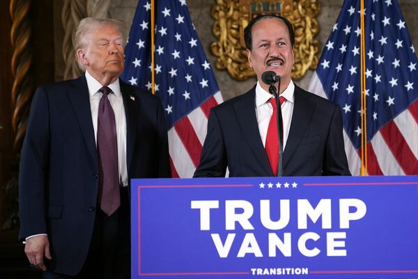 President-elect Donald Trump listens as Hussain Sajwani, CEO of DAMAC Properties, speaks during a news conference at Mar-a-Lago, Tuesday, Jan. 7, 2024, in Palm Beach, Fla. (AP Photo/Evan Vucci)