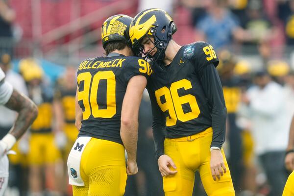 Michigan place kicker Dominic Zvada (96) celebrates his field goal against Alabama with holder Hudson Hollenbeck (90) during the first half of the ReliaQuest Bowl NCAA college football game Tuesday, Dec. 31, 2024, in Tampa, Fla. (AP Photo/Chris O'Meara)