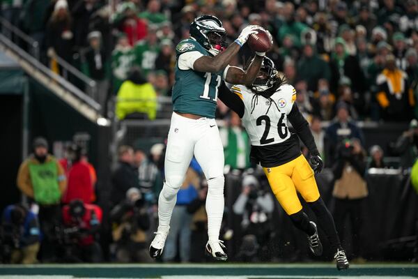 Philadelphia Eagles wide receiver A.J. Brown (11) pulls in the ball for a touchdown in front of Pittsburgh Steelers cornerback Donte Jackson (26) during the first half of an NFL football game Sunday, Dec. 15, 2024, in Philadelphia. (AP Photo/Matt Slocum)