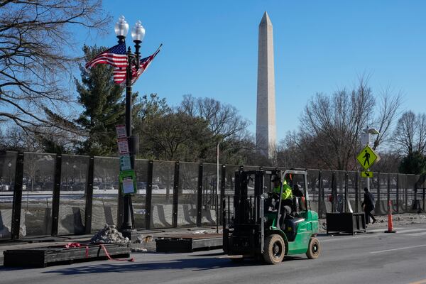 FILE - Workers install security fencing around the Ellipse near the White House ahead of the upcoming inauguration of President-elect Donald Trump in Washington, Jan. 14, 2025. (AP Photo/Jon Elswick, File)