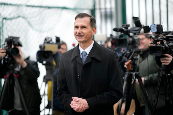 Presidential candidate Dragan Primorac talks to media during a runoff vote for the Croatian presidential election at a polling station in Zagreb, Croatia, Sunday, Jan. 12, 2025. (AP Photo/Darko Bandic)