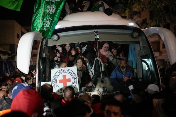 A bus carrying released Palestinian prisoners arrives to the West Bank city of Beitunia, early Monday Jan. 20, 2025. (AP Photo/Leo Correa)