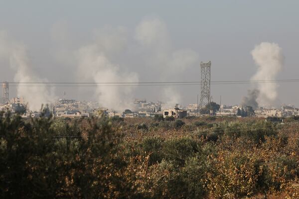 Smoke from fighting billows in the edges of the town of Hama, Syria, Tuesday Dec. 3, 2024.(AP Photo/Ghaith Alsayed)