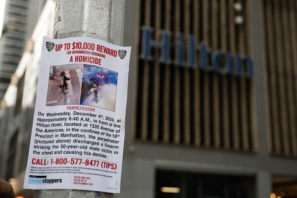 A reward poster hangs on a light pole outside the Hilton Hotel in midtown Manhattan where Brian Thompson, the CEO of UnitedHealthcare, was fatally shot ,Wednesday, Dec. 4, 2024, in New York. (AP Photo/Stefan Jeremiah)