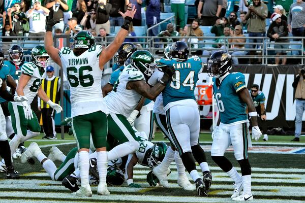 New York Jets running back Breece Hall (20) scores against the Jacksonville Jaguars on a 1-yard run during the second half of an NFL football game Sunday, Dec. 15, 2024, in Jacksonville, Fla. (AP Photo/John Raoux)