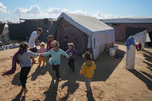 FILE - Children play next to their tent in a refugee camp in Deir al-Balah, Gaza Strip, on Nov. 19, 2024. (AP Photo/Abdel Kareem Hana, File)