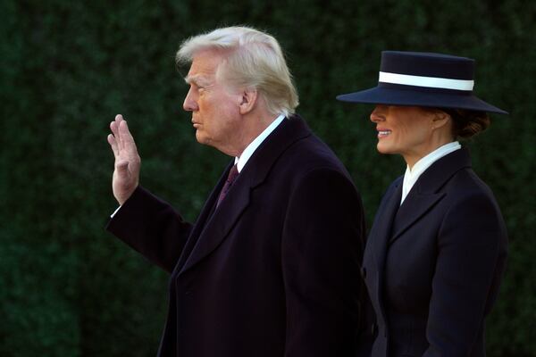 President-elect Donald Trump waves as he walks with his wife Melania after a church service at St. John's Episcopal Church across from the White House in Washington, Monday, Jan. 20, 2025, on Donald Trump's inauguration day. (AP Photo/Matt Rourke)