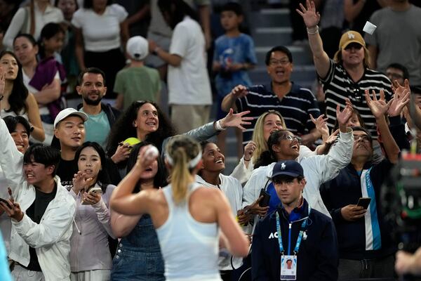 FILE - Paula Badosa of Spain throws some clothing into the crowd after defeating Wang Xinyu of China in their first round match at the Australian Open tennis championship in Melbourne, Australia, Sunday, Jan. 12, 2025. (AP Photo/Ng Han Guan, File)