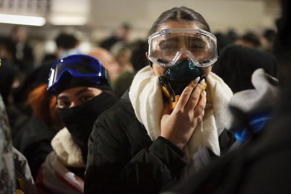 Demonstrators stand in front of police during a rally outside the parliament's building to protest the government's decision to suspend negotiations on joining the European Union for four years in Tbilisi, Georgia, on Saturday, Nov. 30, 2024. (AP Photo/Zurab Tsertsvadze)