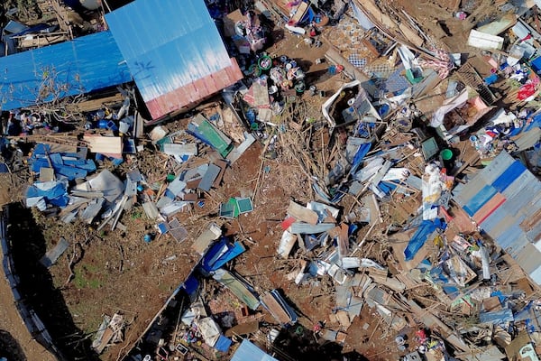 This aerial view shows destroyed homes in the Barakani, Mayotte, informal settlement, Saturday, Dec. 21, 2024. (AP Photo/Adrienne Surprenant)