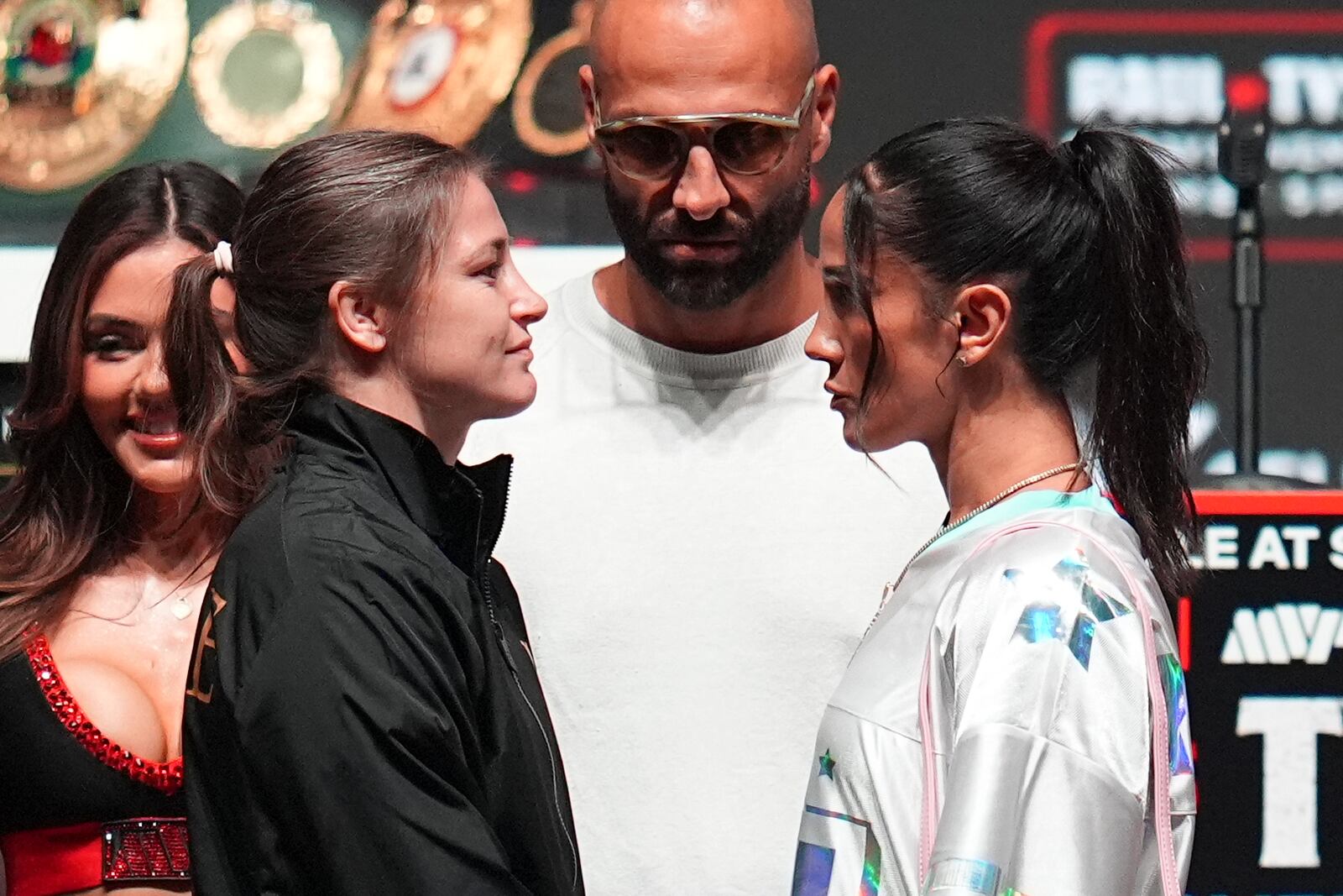 Katie Taylor, front left, and Amanda Serrano, front right, face off during a news conference ahead of her undisputed super lightweight world title bout, the co-main event in the Mike Tyson vs. Jake Paul fight night, Wednesday, Nov. 13, 2024, in Irving, Texas. (AP Photo/Julio Cortez)