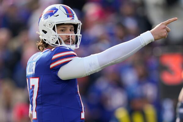 Buffalo Bills quarterback Josh Allen (17) motions for a first down during the first quarter of an NFL wild card playoff football game against the Denver Broncos, Sunday, Jan. 12, 2025, in Orchard Park, N.Y. (AP Photo/Seth Wenig)