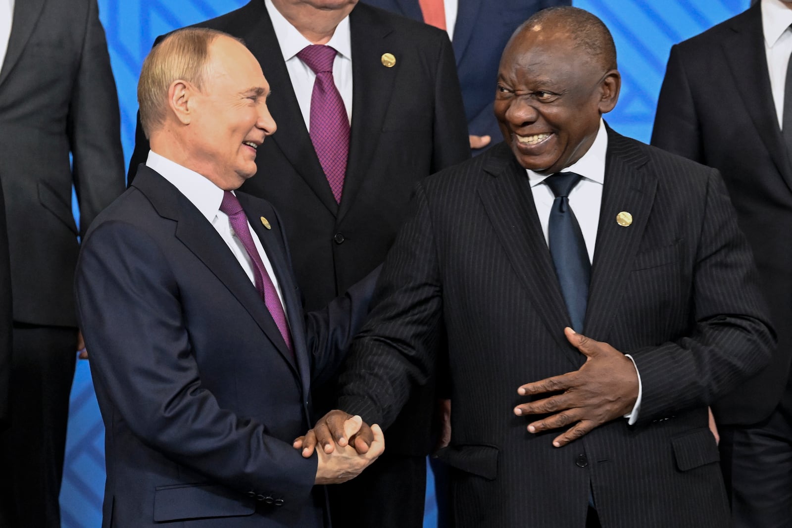 Russian President Vladimir Putin, left, and South African President Cyril Ramaphosa shake hands during a family photo ceremony prior to Outreach/BRICS Plus format session at BRICS Summit in Kazan, Russia, Thursday, Oct. 24, 2024. (Alexander Nemenov, Pool Photo via AP)