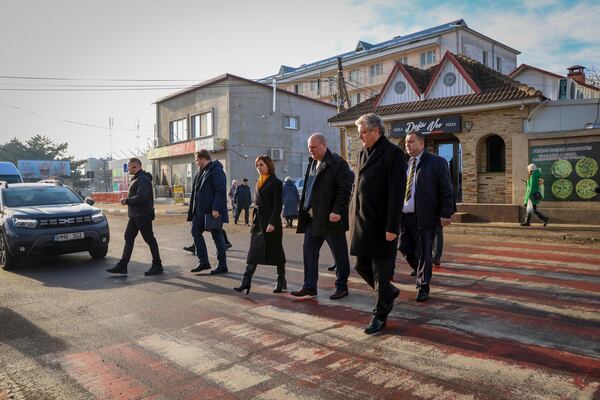 Moldova's President Maia Sandu crosses a road during a visit to areas affected by gas and electricity shortages in Varnita, Moldova, Thursday, Jan. 9, 2025. (AP Photo/Aurel Obreja)