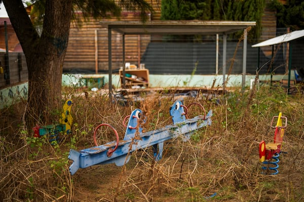 The weeds grow in a deserted kindergarten playground in Shlomi, northern Israel, near to the border with Lebanon, Wednesday, Nov. 27, 2024. (AP Photo/Francisco Seco)