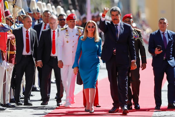 Venezuelan President Nicolas Maduro and his wife Cilia Flores arrive at the National Assembly for his swear-in ceremony for a third term in Caracas, Venezuela, Friday, Jan. 10, 2025. (AP Photo/Cristian Hernandez)