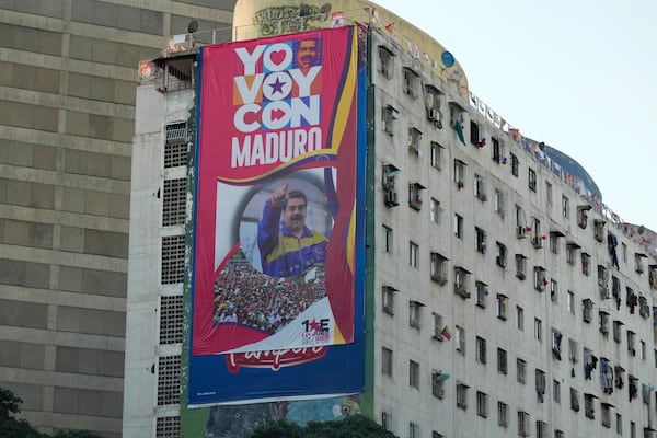 A campaign banner of President Nicolas Maduro adorns a building in Caracas, Venezuela, Wednesday, Jan 8, 2025. (AP Photo/Ariana Cubillos)