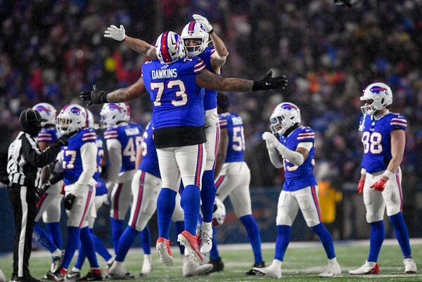 Buffalo Bills offensive tackle Dion Dawkins (73) and tight end Dalton Kincaid (86) celebrate as time winds off the clock of an NFL divisional playoff football game against the Baltimore Ravens, Sunday, Jan. 19, 2025, in Orchard Park, N.Y. (AP Photo/Adrian Kraus)