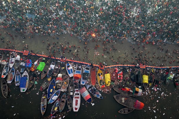 Hindu devotees gather to take a holy dip in the Sangam, the confluence of the Ganges, the Yamuna and the mythical Saraswati rivers, on "Mauni Amavasya" or new moon day during the Maha Kumbh festival in Prayagraj, India, Wednesday, Jan. 29, 2025. (AP Photo/Rajesh Kumar Singh)