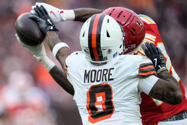 Kansas City Chiefs safety Nazeeh Johnson (13) breaks up a pass intended for Cleveland Browns wide receiver Elijah Moore (8) during the first half of an NFL football game, Sunday, Dec. 15, 2024, in Cleveland. (AP Photo/Sue Ogrocki)