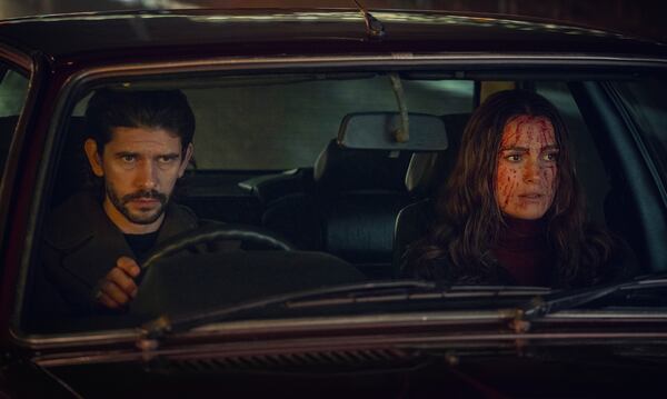 This image released by Netflix shows Ben Whishaw, left, and Keira Knightley in a scene from "Black Doves." (Ludovic Robert/Netflix via AP)