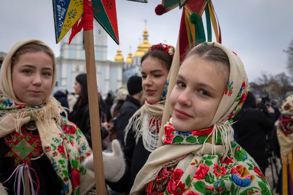 Girls in national costumes celebrate Christmas near St. Michael Monastery in a city centre in Kyiv, Ukraine, Wednesday, Dec. 25, 2024. (AP Photo/Efrem Lukatsky)