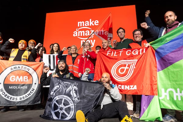 To mark the Black Friday discount day, around 400 to 500 Amazon employees from Germany joined colleagues from the USA, Sweden, the UK and Italy at the international protest center in Bad Hersfeld,Germany, and took part in the central strike meeting in the Schilde Hall, Friday, Nov. 29, 2024. (Christian Lademann/dpa via AP)