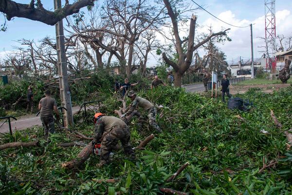 This photo provided Sunday Dec.15, 2024 by the French Army shows soldiers removing fallen trees in the French territory of Mayotte in the Indian Ocean, after Cyclone Chido caused extensive damage with reports of several fatalities. (Etat Major des Armées via AP)