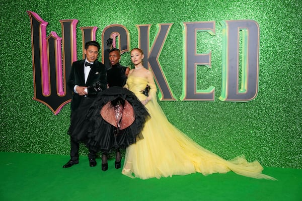 Director Jon M. Chu, from left, Cynthia Erivo and Ariana Grande pose for photographers upon arrival at the premiere of the film 'Wicked' on Monday, Nov. 18, 2024, in London. (Photo by Scott A Garfitt/Invision/AP)