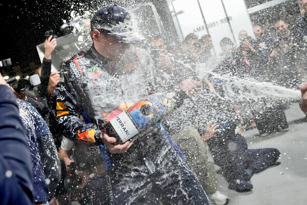 Red Bull driver Max Verstappen, of the Netherlands, celebrates winning the Formula 1 championship with his team after the F1 Las Vegas Grand Prix auto race, Sunday, Nov. 24, 2024, in Las Vegas. (AP Photo/Matt York)