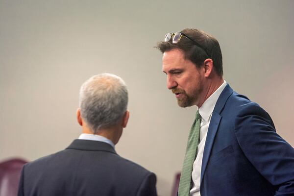 Prosecutor John Fowler, right, talks with defense attorney Brian Steel on Tuesday, Jan. 21, 2025, at the Glynn County courthouse in Brunswick, Ga., as jury selection begins in the trial of former District Attorney Jackie Johnson. She’s charged with interfering in the police investigation of the 2020 killing of Ahmaud Arbery. (Michael Hall/The Brunswick News via AP, Pool)