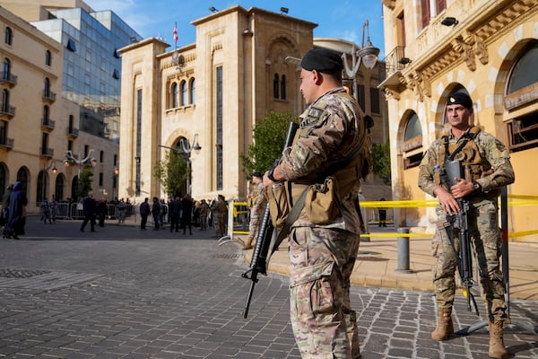 Lebanese army soldiers stand guard in front of the parliament building before a session to elect a new Lebanese president in down town Beirut, Lebanon, Thursday, Jan. 9, 2025. (AP Photo/Hussein Malla)