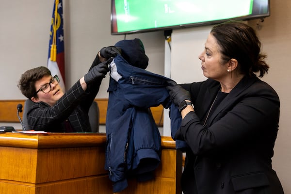 Witness Katrina Ostapovicz, left, a crime lab scientist with the Georgia Bureau of Investigation, and prosector Sheila Ross hold a jacket allegedly worn by defendant Jose Ibarra as Ostapovicz testifies during Ibarra's trial at the Athens-Clarke County Superior Court, Tuesday, Nov. 19, 2024, in Athens, Ga. (Arvin Temkar/Atlanta Journal-Constitution via AP, Pool)