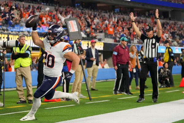 Denver Broncos fullback Michael Burton celebrates after catching a touchdown pass during the first half an NFL football game against the Los Angeles Chargers, Thursday, Dec. 19, 2024, in Inglewood, Calif. (AP Photo/Eric Thayer)