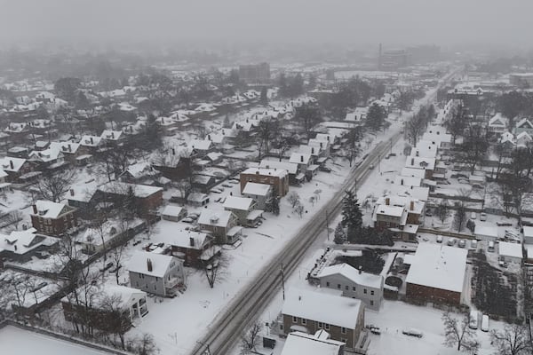 Snow covers homes during a winter storm, Monday, Jan. 6, 2025, in Cincinnati. (AP Photo/Joshua A. Bickel)