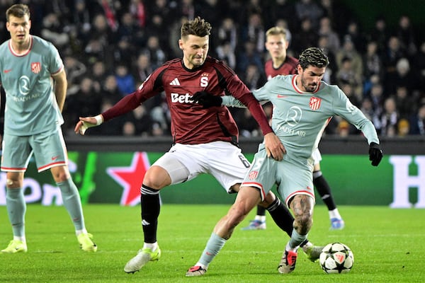 Kaan Kairinen of Sparta Praha, left, and Atletico's Rodrigo De Paul, right, challenge for the ball during the UEFA Champions League opening phase soccer match between between Sparta Prague and Athletico Madrid in Prague, Czech Republic, Tuesday, Nov. 26, 2024. (Roman Vondrous//CTK via AP)