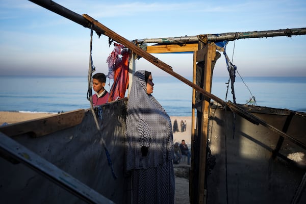 A woman stands in her damaged tent following an Israeli army strike in Deir Al-Balah in the central Gaza Strip, Tuesday, Jan. 14, 2025. (AP Photo/Abdel Kareem Hana)