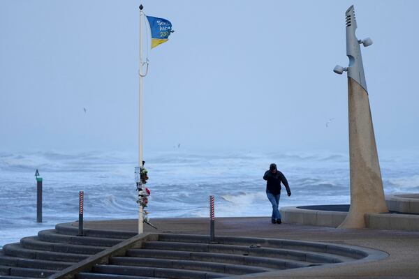 A man braves the wind as storm Eowyn hits the country in Cleveleys, near Blackpool, England, Friday, Jan. 24, 2025.(AP Photo/Jon Super)