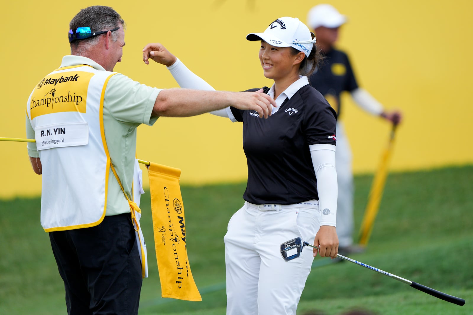 Yin Ruoning of China celebrates with his caddie on the 18th hole after winning the LPGA Tour's Maybank Championship at Kuala Lumpur Golf and Country club in Kuala Lumpur, Sunday, Oct. 27, 2024. (AP Photo/Vincent Thian)