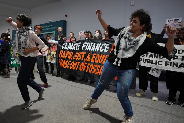 Activists participate in a demonstration for climate finance at the COP29 U.N. Climate Summit, Thursday, Nov. 21, 2024, in Baku, Azerbaijan. (AP Photo/Peter Dejong)