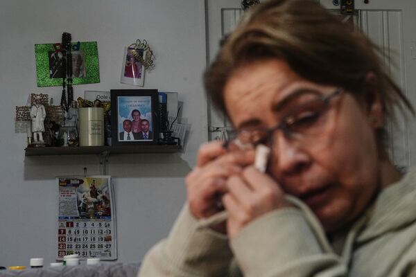 Maria Fenix dries tears during an interview about her missing brothers at her home in Bogota, Colombia, Monday, Nov. 4, 2024. The twin brothers Alexander and Henry vanished on their way to a business meeting in 2007. (AP Photo/Ivan Valencia)