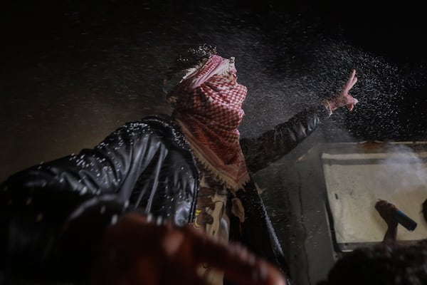 Palestinians celebrate the imminent announcement of a ceasefire deal between Hamas and Israel in Khan Younis, central Gaza Strip, Wednesday, Jan. 15, 2025.(AP Photo/(AP Photo/Jehad Alshrafi)