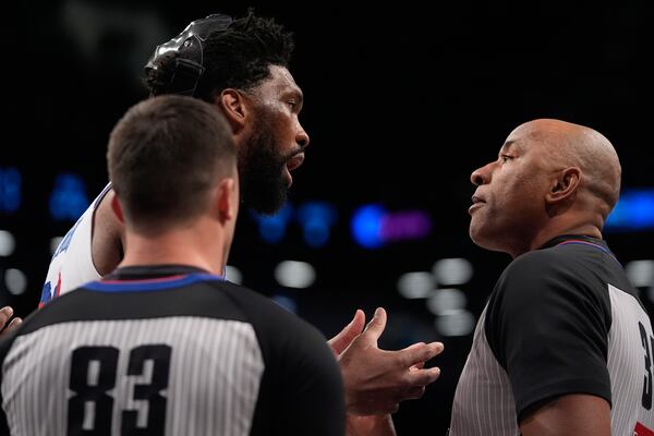 Philadelphia 76ers' Joel Embiid, left, argues a call with referee Kevin Cutler (34) during the first half of an NBA basketball game against the Brooklyn Nets Saturday, Jan. 4, 2025, in New York. (AP Photo/Frank Franklin II)